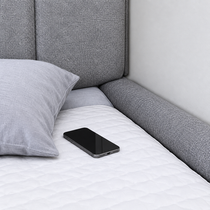 Bed gap filler blocking phone and pillow from falling